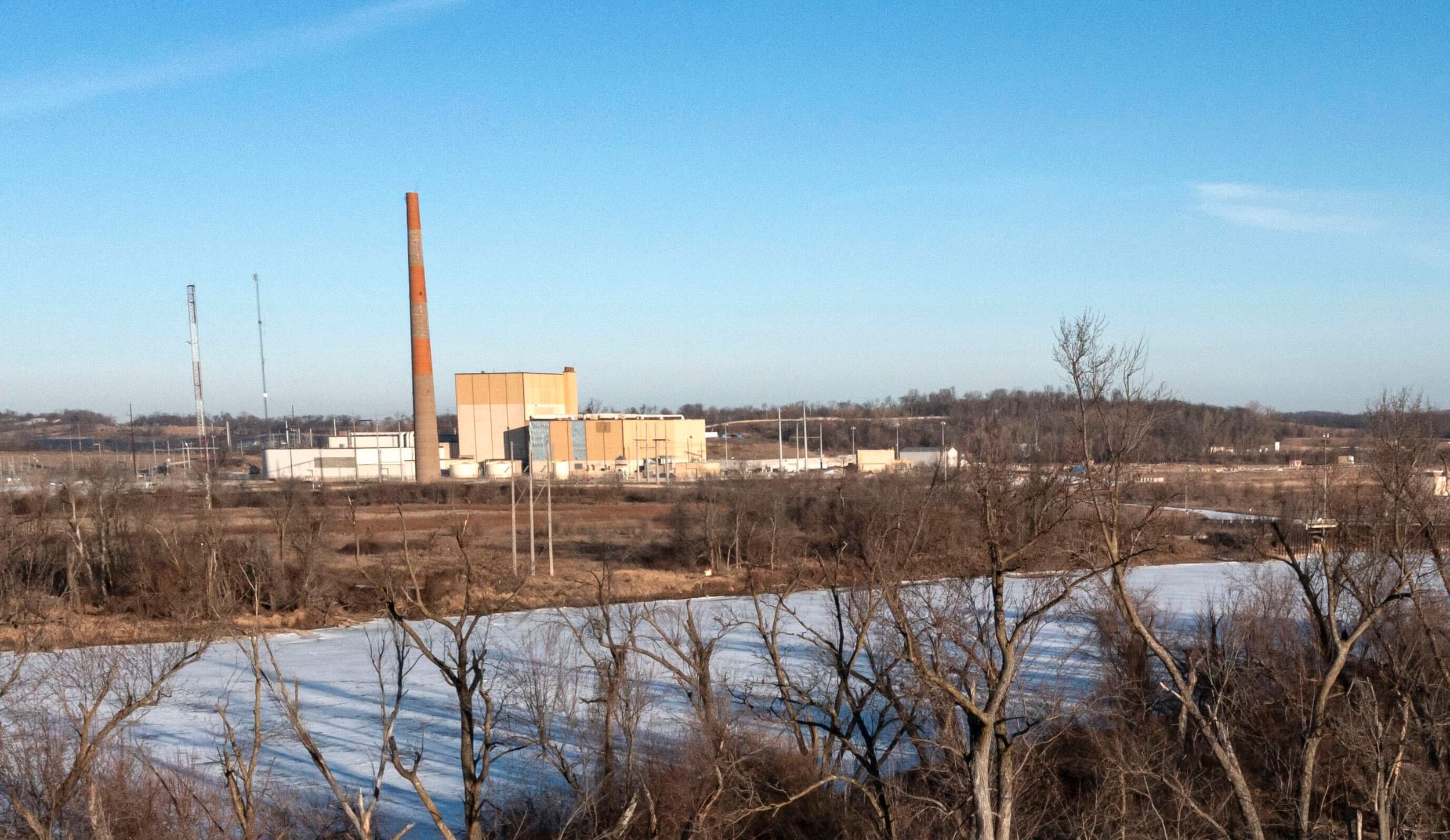 industrial facility surrounded by bleak brush and snow