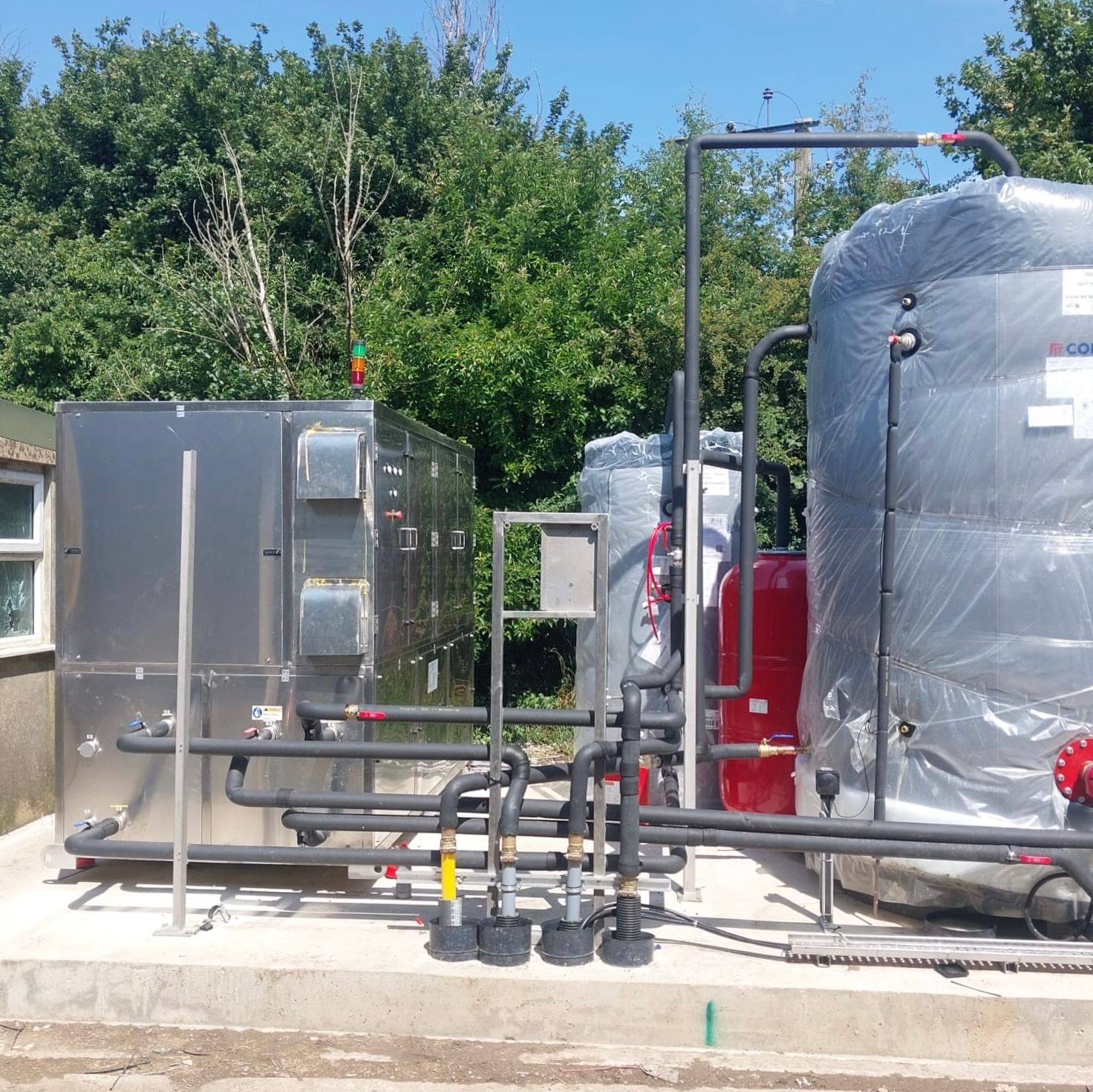 silver mechanical equipment including pipes and water tanks outdoors