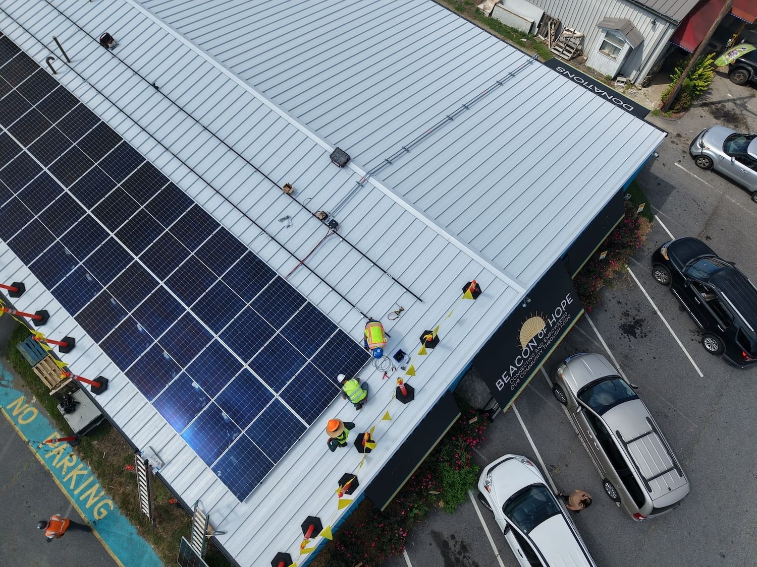 Overhead view of solar panels being installed on Beacon of Hope's white roof