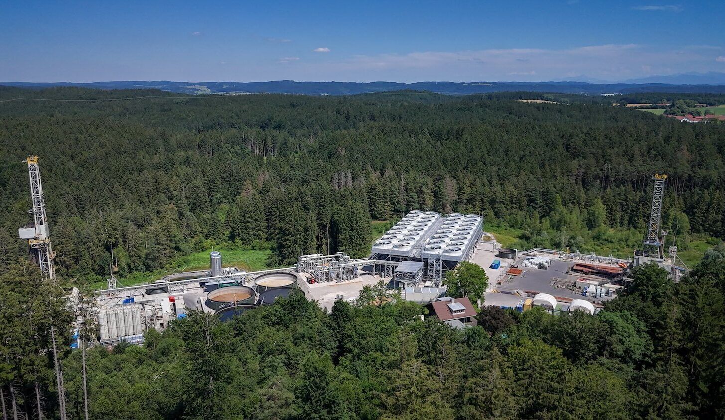 Overhead view of geothermal plant in a forested landscape