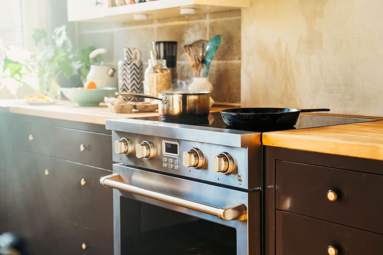 An induction stove with pans on top of its burners