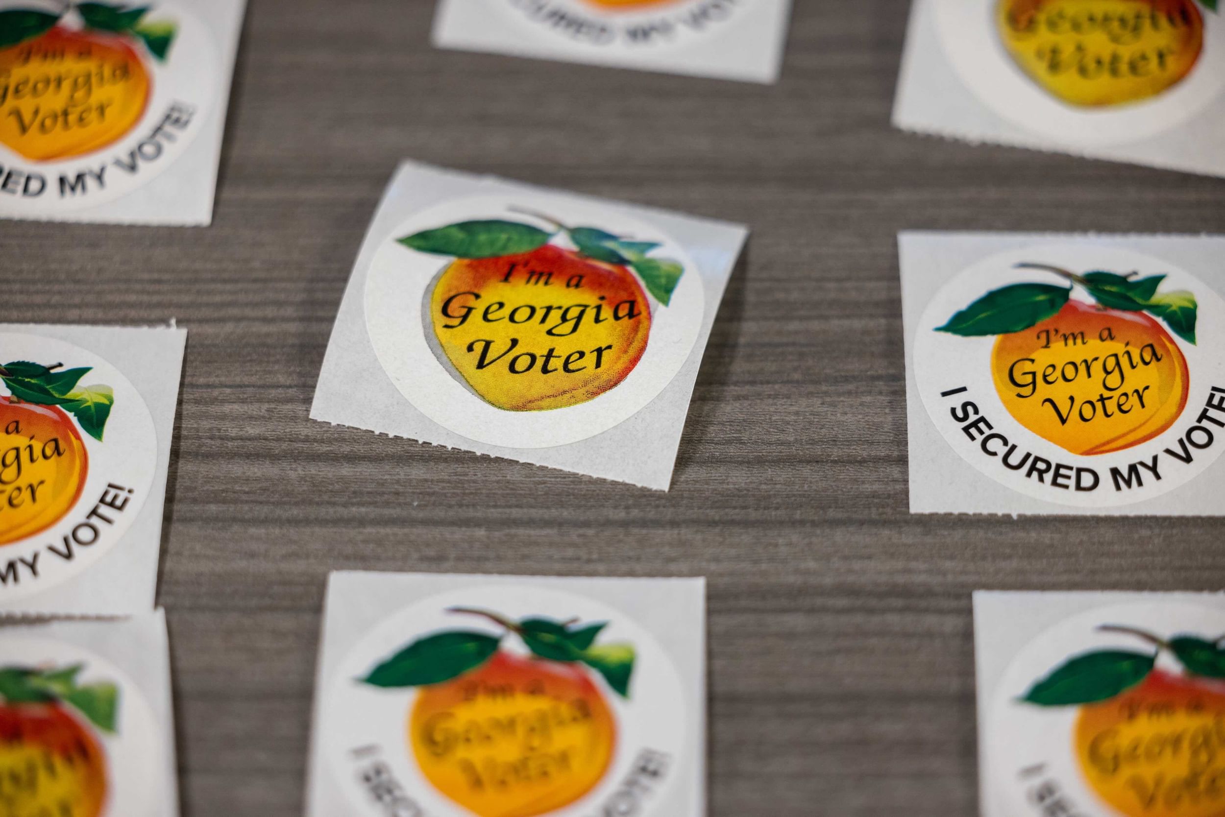 stickers with peaches that say "I'm a Georgia voter. I secured my vote."