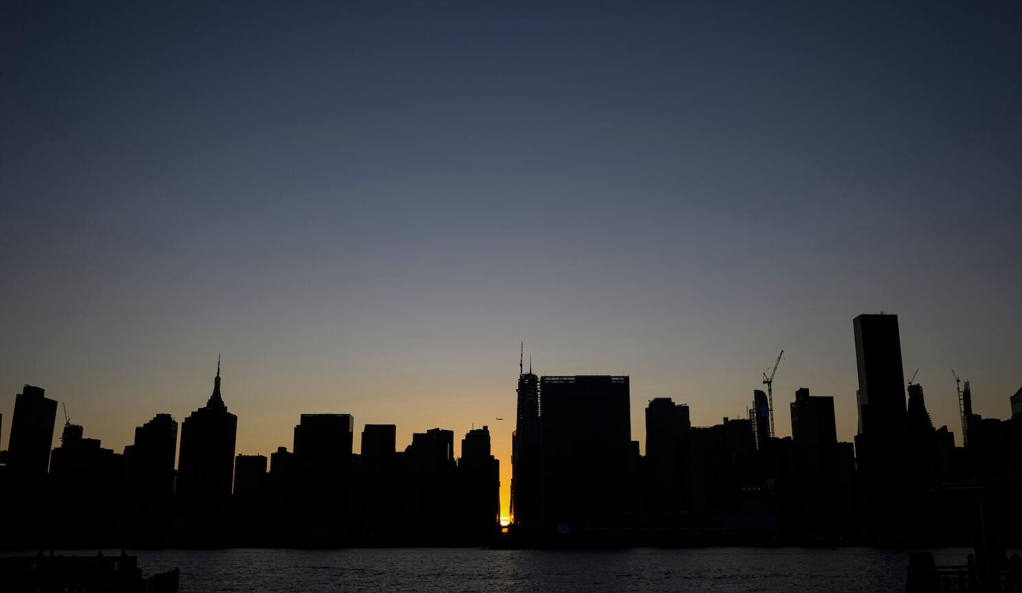 city skyline against sunset