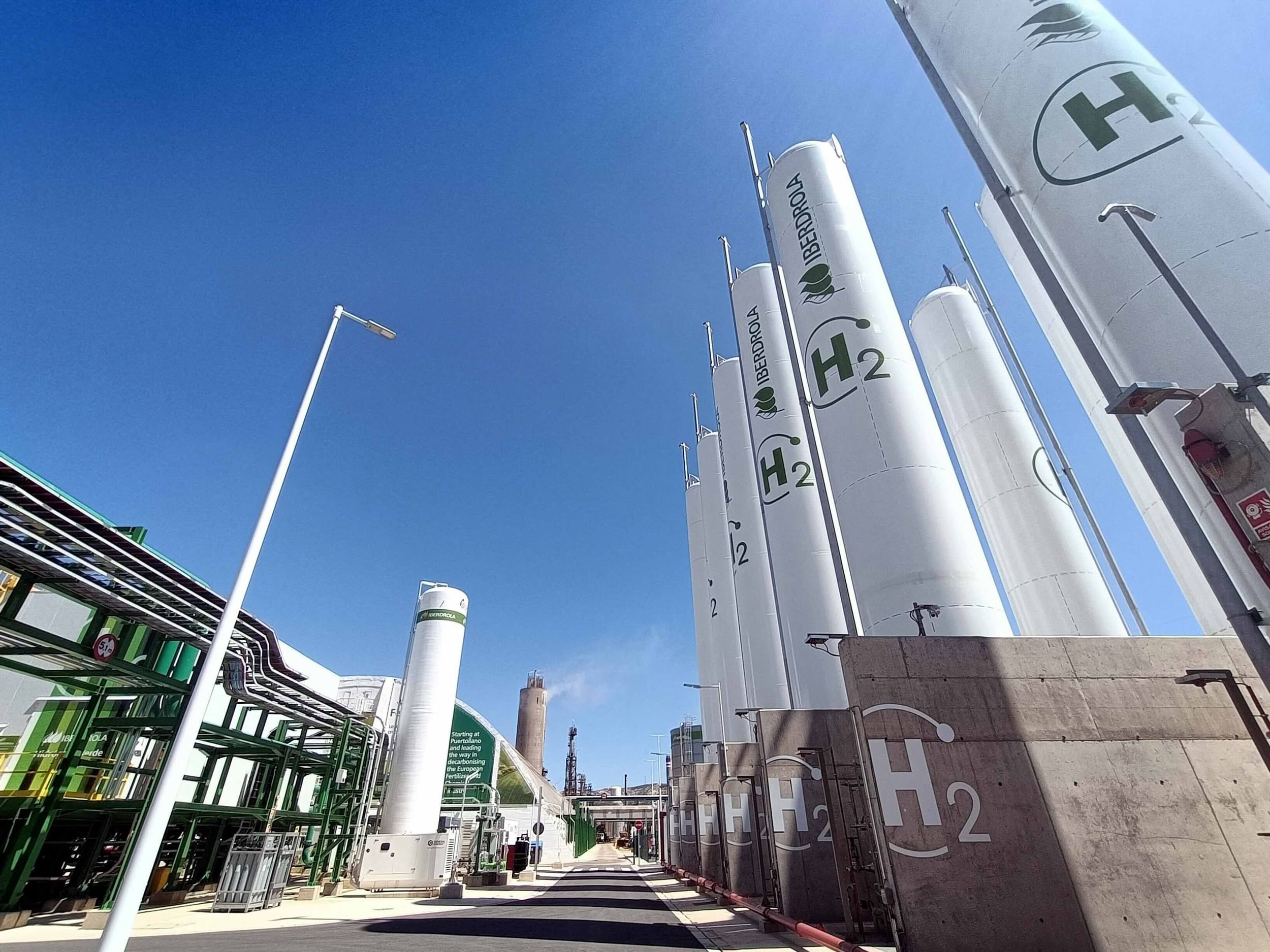 industrial site with white towers and H's