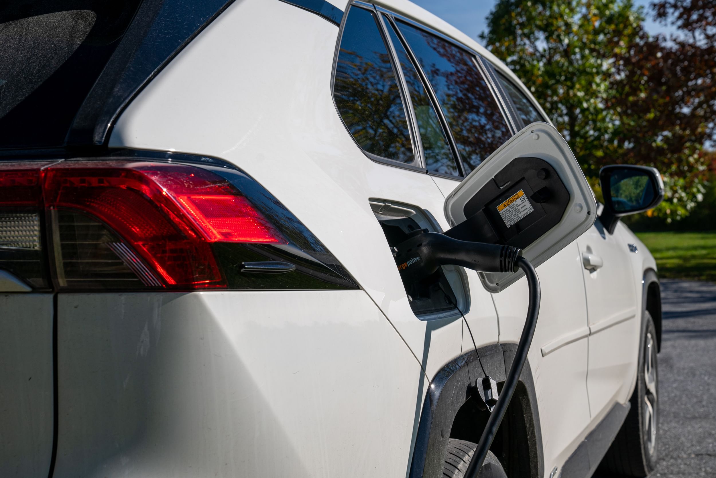 A Toyota EV is plugged in and charging.