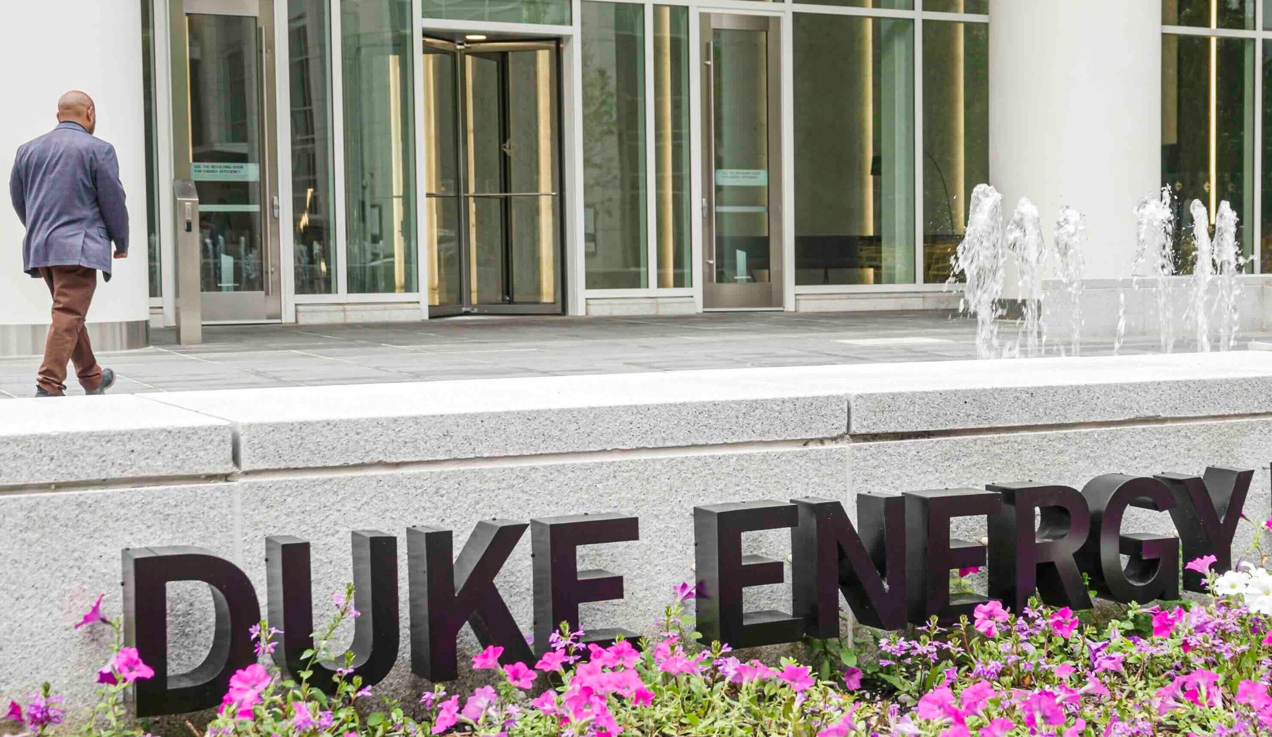 man walking into Duke Energy building