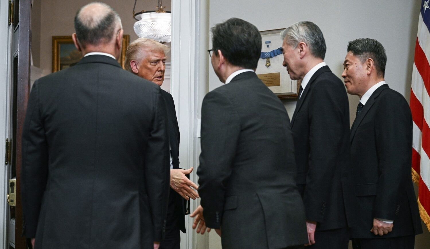 Men in suits shake hands