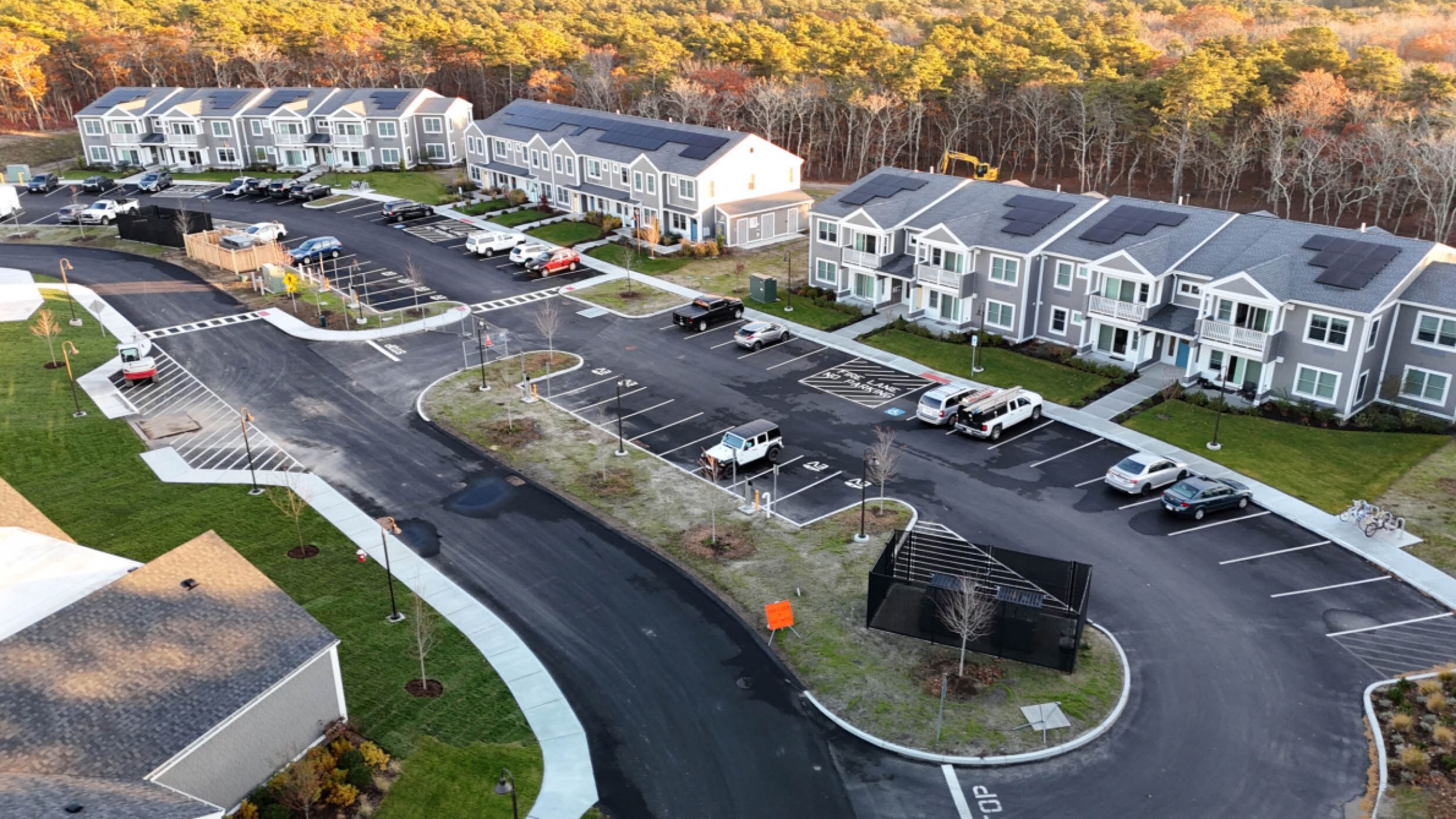 Houses around a parking lot with solar panels on the roofs