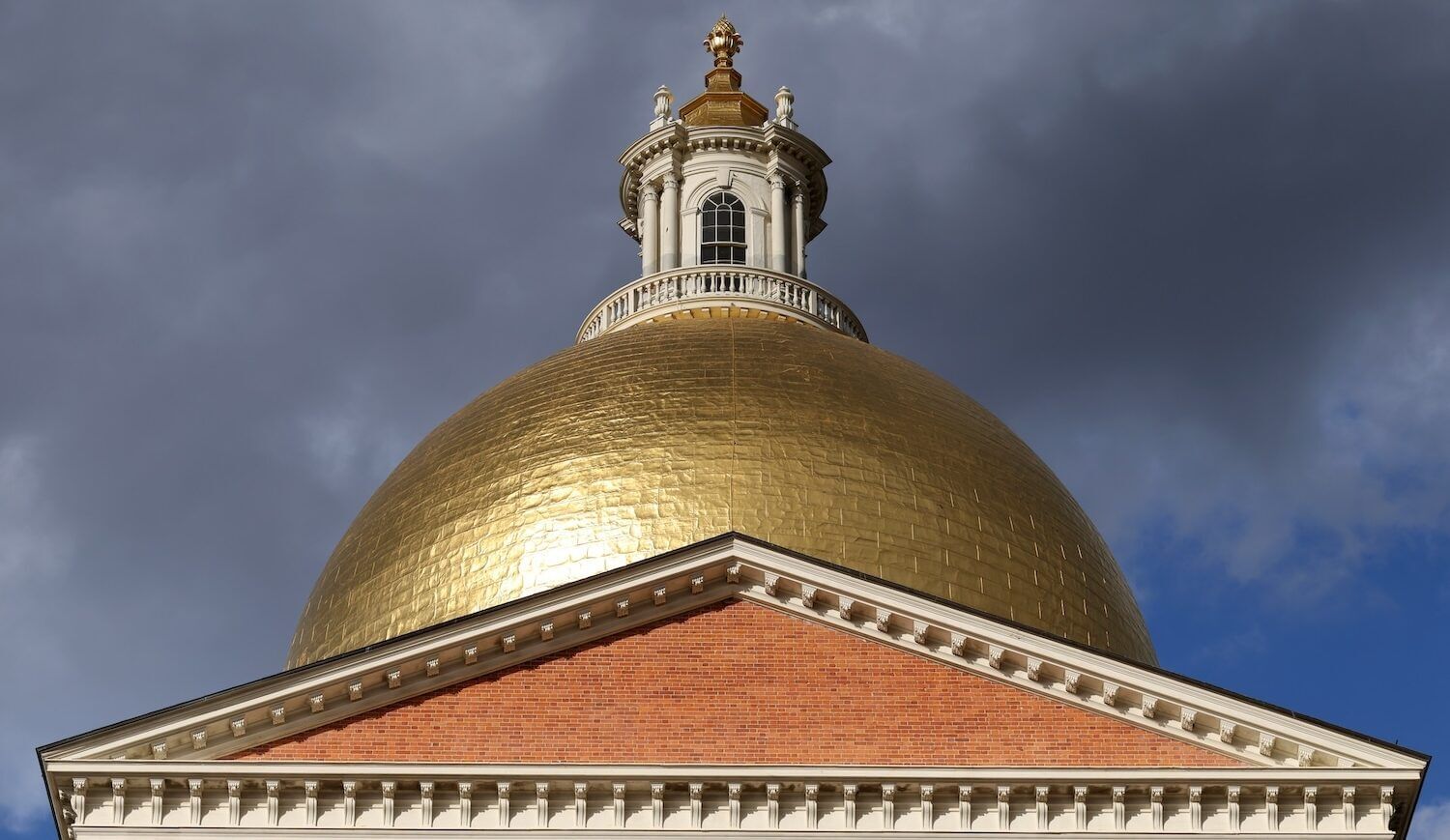 Close-up of golden dome atop a brick