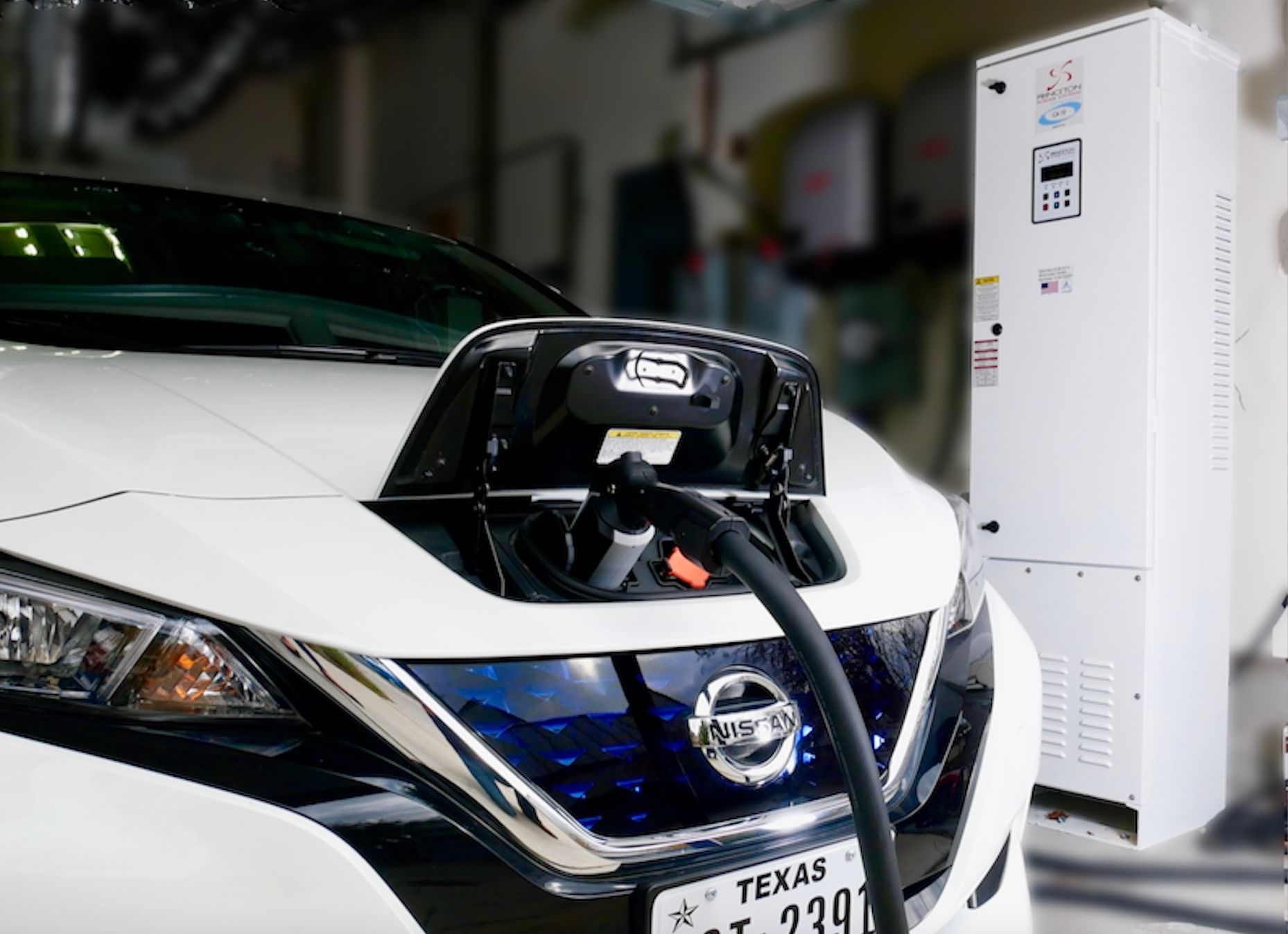 Nissan Leaf plugged into EV charger