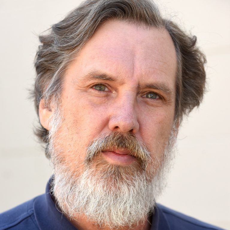 Man with a beard, blue eyes, and a blue shirt