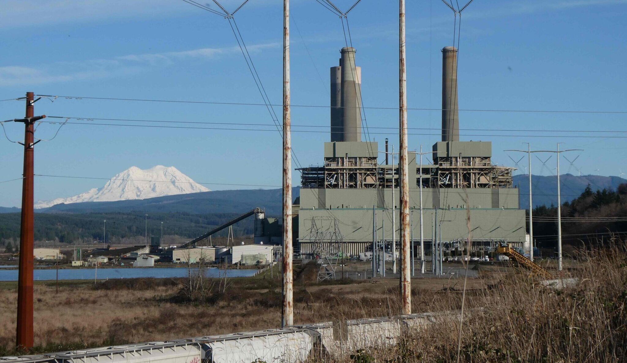 Coal plant with a snowcapped mountain in the distance