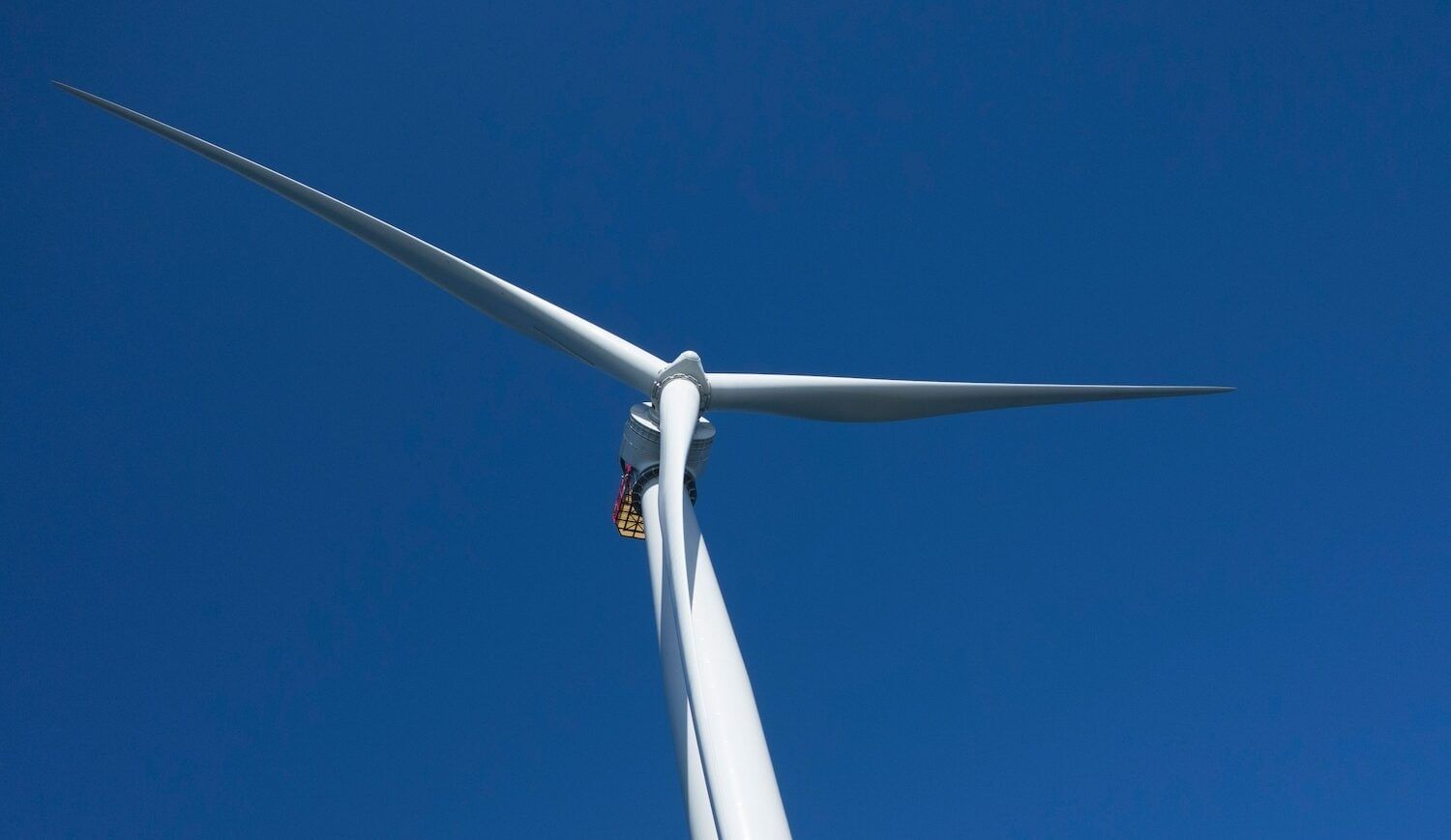 White wind turbine against a blue sky