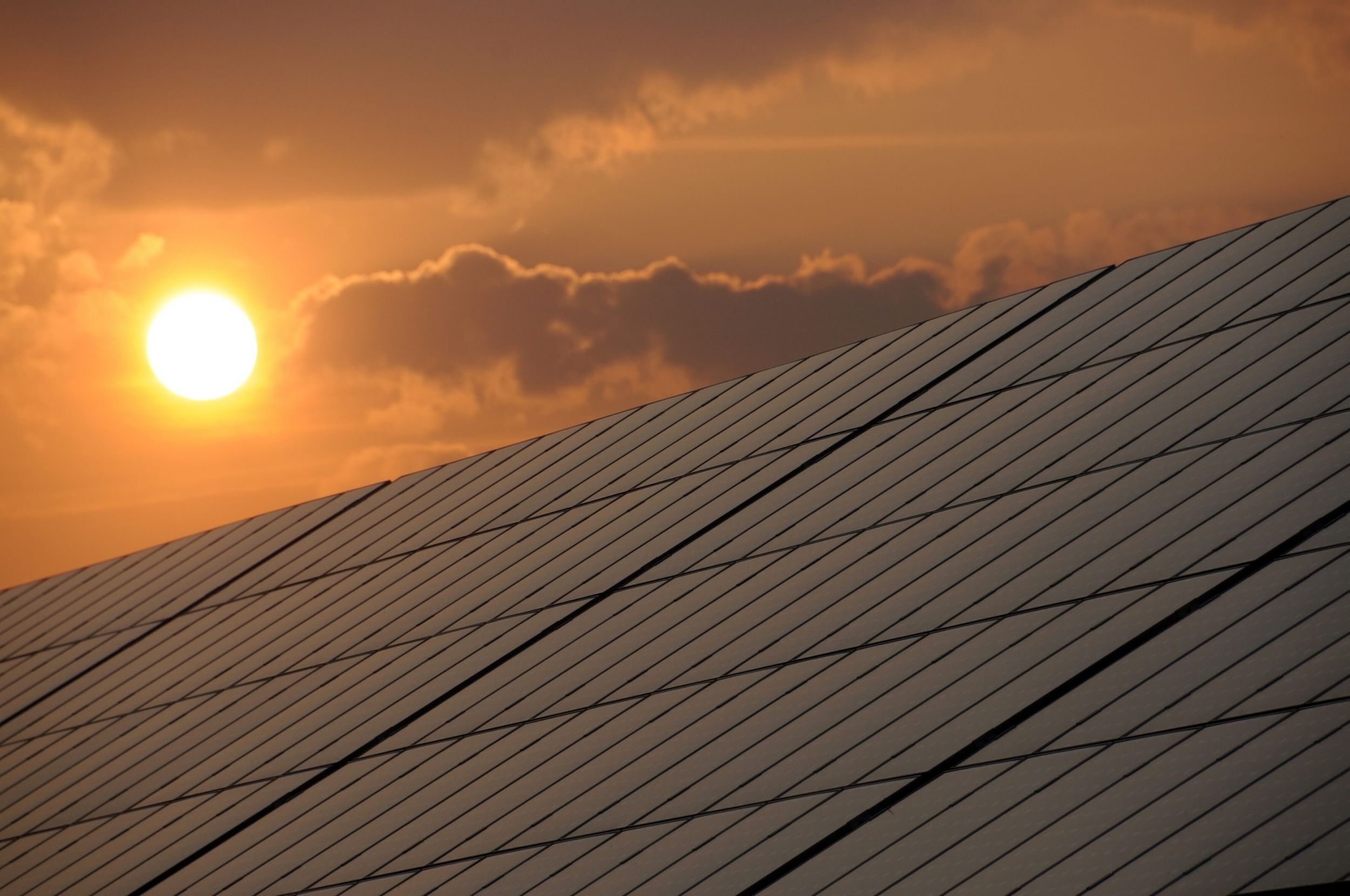 the sun setting over solar panels