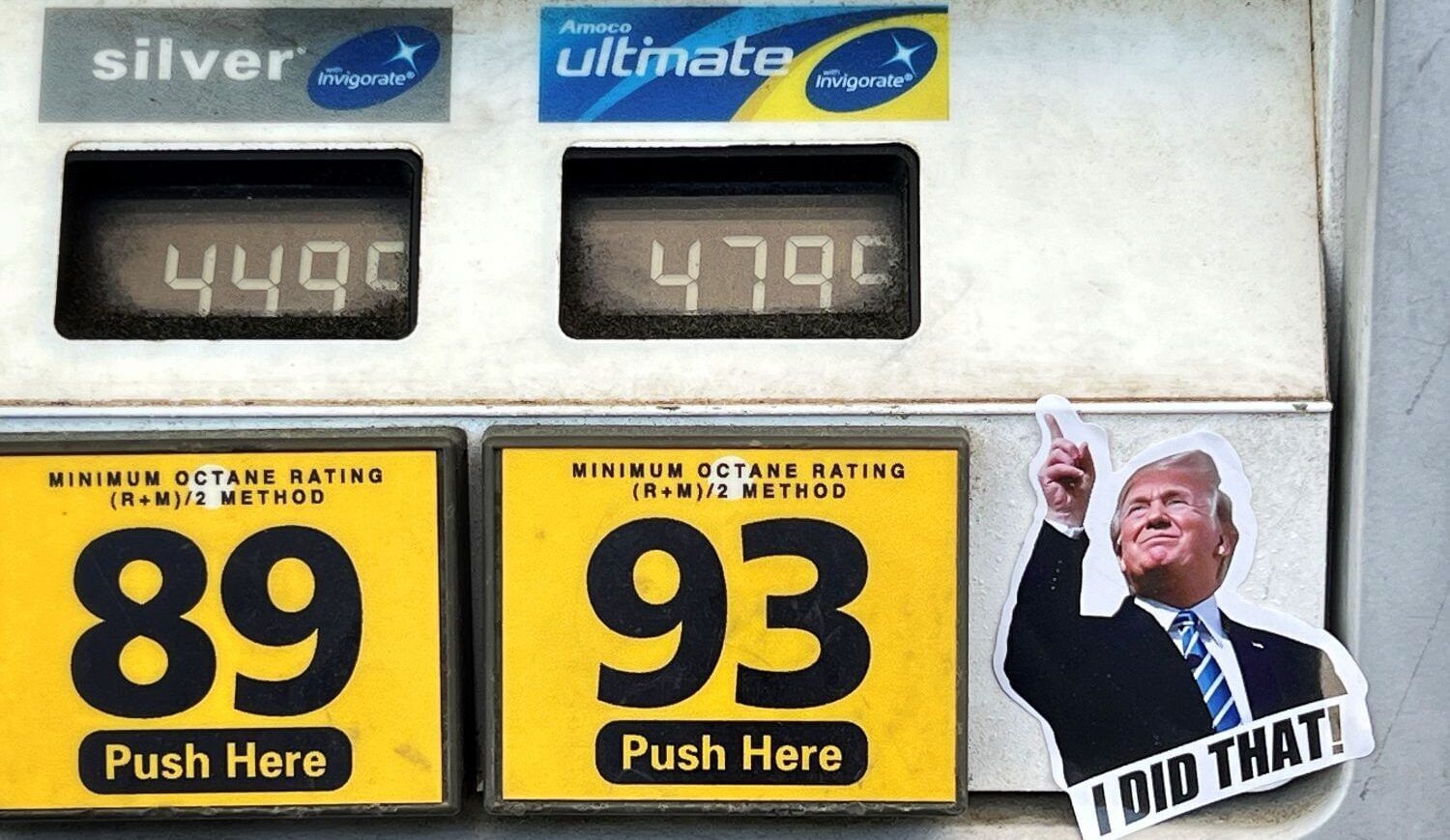 A sticker with Donald Trump that says "I did that" next to prices at a gas pump that are around $4.50.