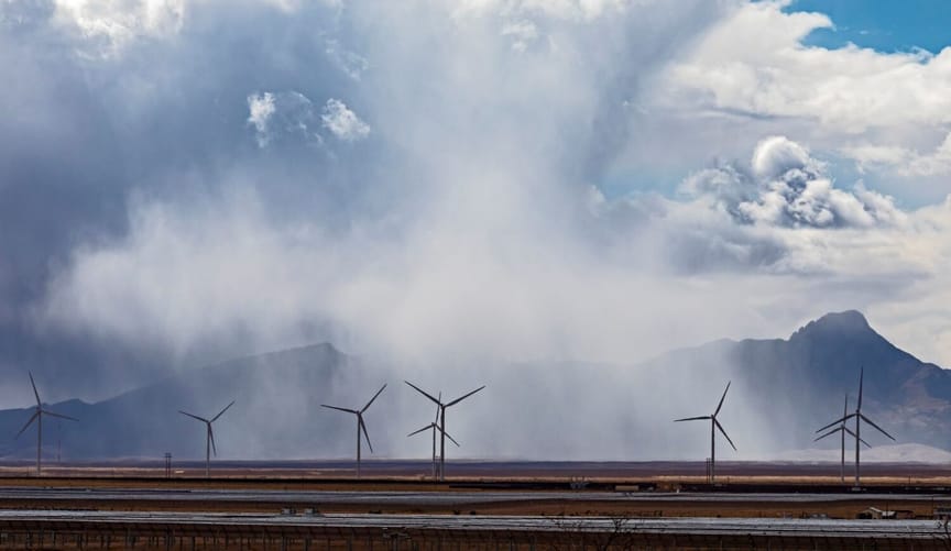 Wind turbines against mountains