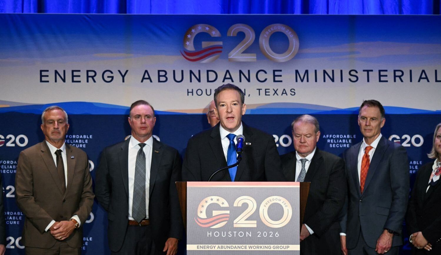 Men in suits stand in front of a sign that says "G20 Energy Abundance Minesterial"
